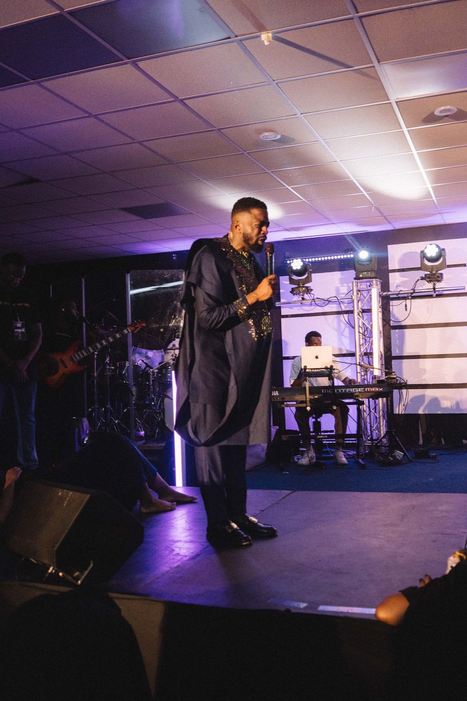 Preaching on stage under purple light